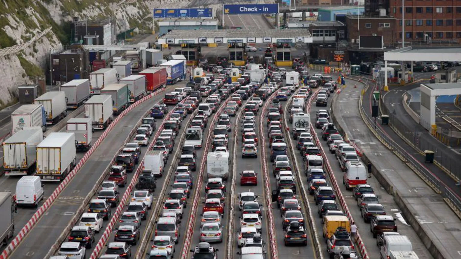 Getty Images Cars queue at the border while waiting to board ferries at the Port of Dover in 2023. There are eight lanes of traffic leading up to the port and on the left hand side there are two lanes of lorries queuing. A road sign with the words 'check in' can be seen up ahead.